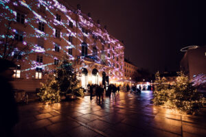 Evening atmosphere in MuseumsQuartier´s main courtyard with illuminated cultural institutions and social gatherings.