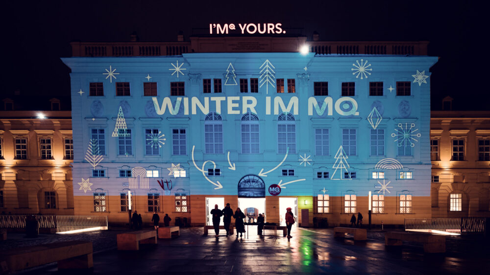 Evening glow of MuseumsQuartier's winter lighting design highlighting architectural features and cultural spaces.