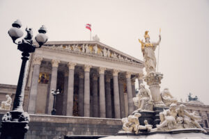 Grand columns and the Athena statue at the entrance of the Austrian Parliament.