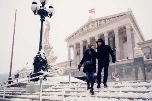 Adriana and Mario at the Austrian Parliament's elegant staircases and grand columns.