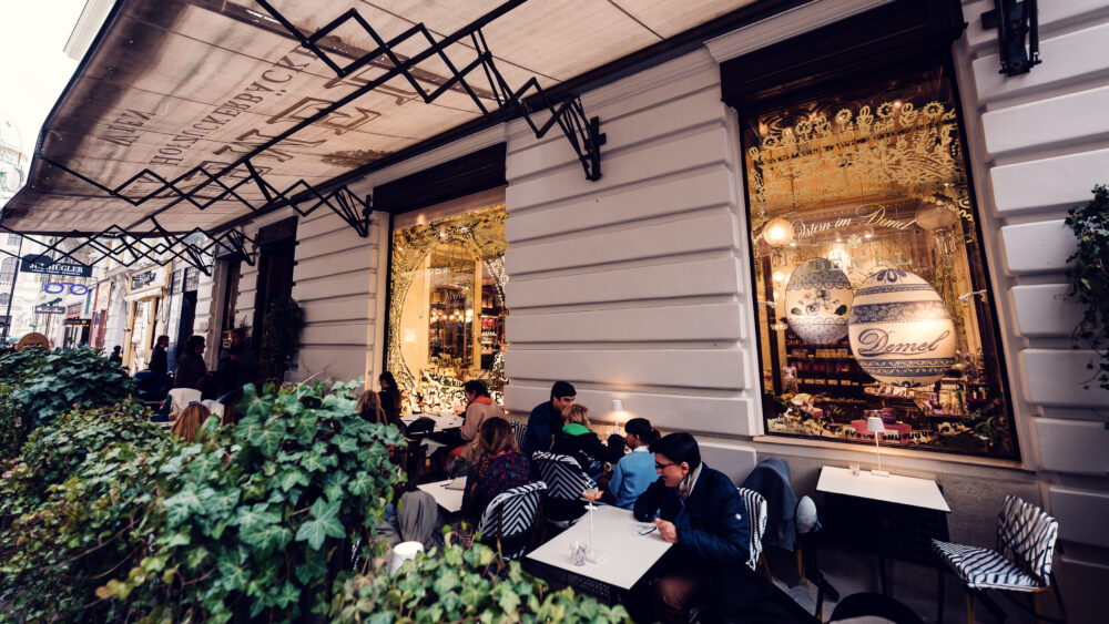 The outdoor terrace at Café Demel, offering charming seating with views of Vienna's bustling streets.