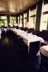 Traditional table settings featuring fine linens and crystal.
