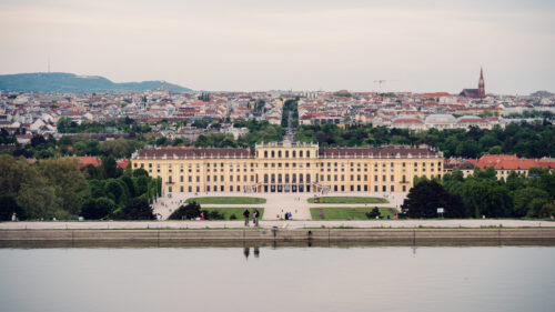 Panoramic view from the Gloriette's terrace, capturing Schönbrunn Palace and Vienna's sprawling landscape in crystal-clear light.