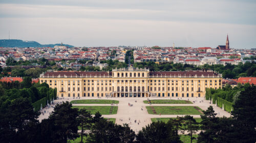 Panoramablick bei Tageslicht von der Terrasse der Gloriette, der Schloss Schönbrunn und Wiens weitläufige Landschaft in kristallklarem Licht einfängt.
