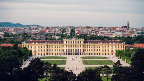 Panoramic daytime view from the Gloriette's terrace, capturing Schönbrunn Palace and Vienna's sprawling landscape in crystal-clear light.