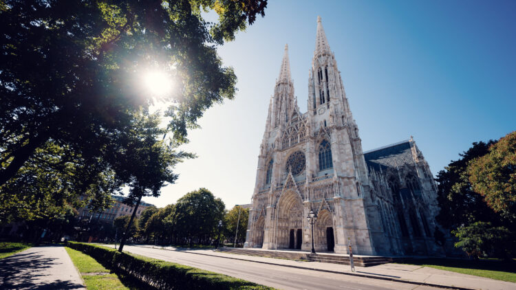 Votive Church (Votivkirche) Vienna, a neo-Gothic masterpiece with twin spires reaching 99 meters, featuring pointed arches, flying buttresses, and intricate stone tracery.