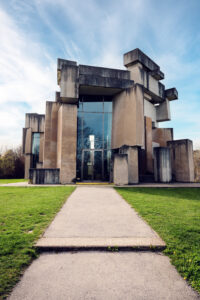 Serene setting of Wotrubakirche, blending modern architecture with the tranquility of its surroundings.