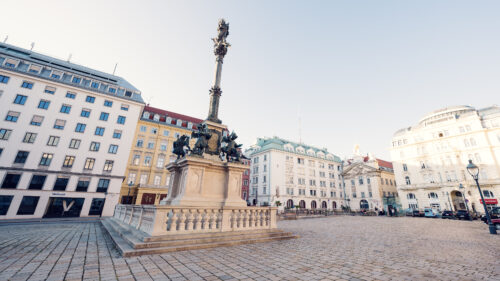 The Marian Column am Hof, Vienna, is a prominent monument featuring a statue of the Virgin Mary, surrounded by elegant Baroque architectural elements, symbolizing protection and grace.