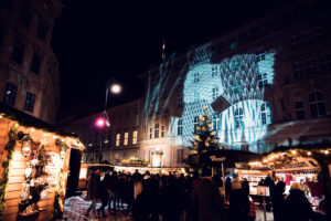 Visitors enjoying the festive ambiance of the Christmas market at Freyung Square in Vienna.