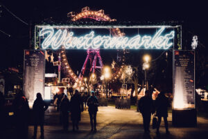 Prater Christmas market entry with festive decorations and seasonal stalls in historic Prater park winter setting.