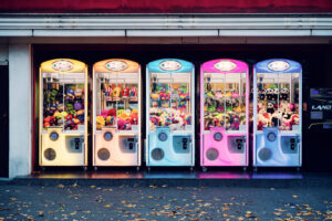 Plush toy vending machines at Prater Vienna Austria, carnival game automats with stuffed animals and prizes in historic Wiener Prater amusement park.