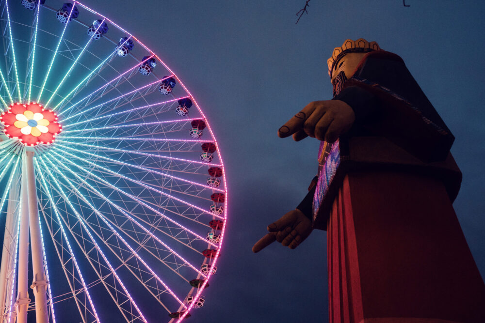 Additional Ferris wheel attraction at Prater Vienna, compact carnival ride with passenger gondolas and classic amusement park design in traditional Wiener Prater.