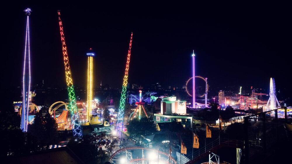 Prater Vienna at night, illuminated amusement park with glowing rides and festive lighting in historic Wiener Prater district.