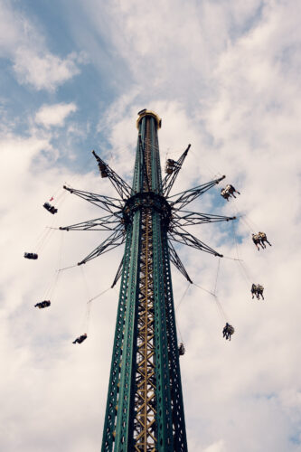 Prater Turm high carousel at Wiener Prater Vienna Austria, elevated rotating ride with passenger gondolas and panoramic city views in historic Prater amusement park.