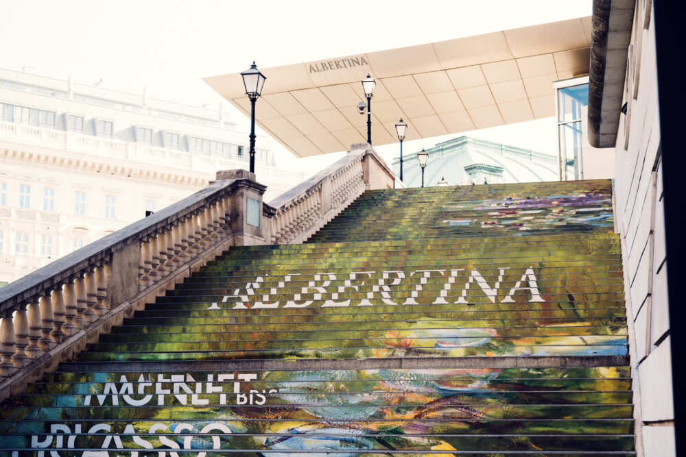 View of the entrance stairs and Albertina Museum signage in Vienna.