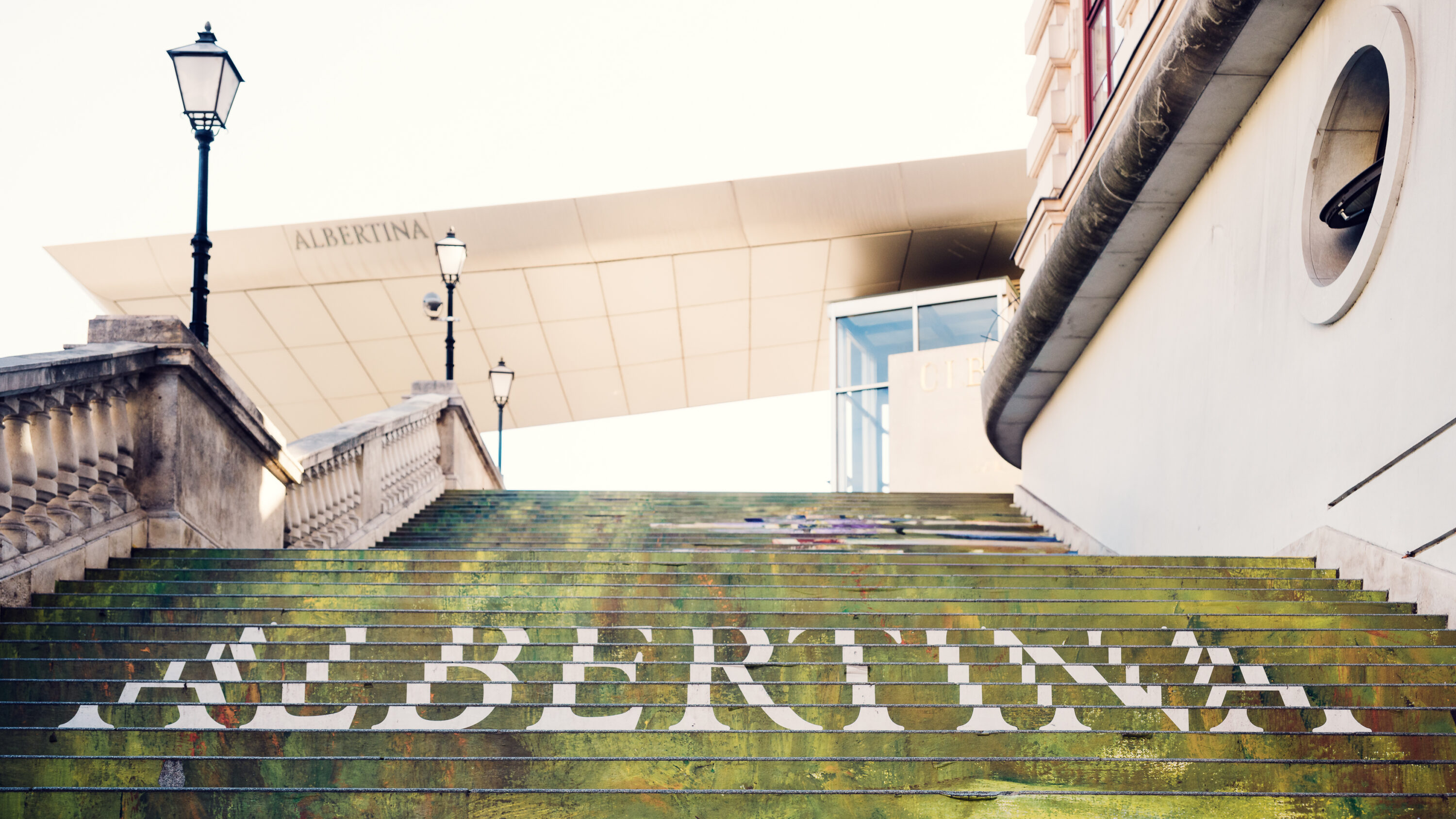 Albertina Museum's name displayed on the stairs near the main entrance.