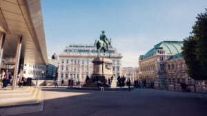 Albertina Museum entrance with modern overhanging roof and historical surroundings.