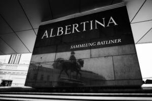 Black and white photo of Albertina Museum entrance with Sammlung Batliner sign.