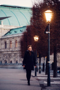 Walking near Albertina Museum and its surrounding historical buildings at night.