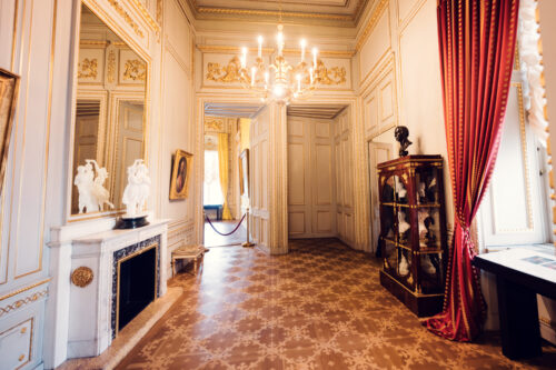 Luxurious interior of Albertina Museum with antique furniture and chandelier.