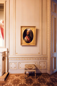 Historical room in Albertina Museum featuring vintage paintings and decor.