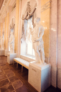 Elegant marble statues in the neoclassical interior of Albertina Museum in Vienna.