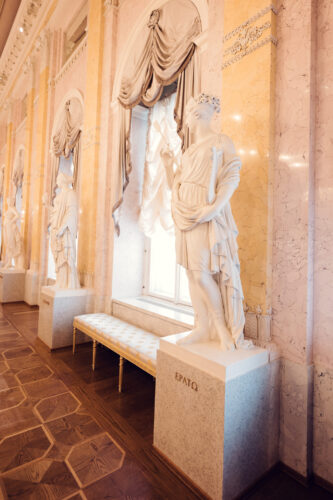 Elegant marble statues in the neoclassical interior of Albertina Museum in Vienna.