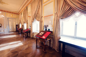 Luxurious room with antique furnishings and draped curtains in Albertina Museum.