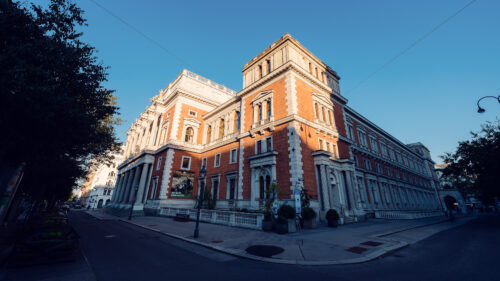 The Vienna Stock Exchange is a grand and historic building featuring red-brick facades and neoclassical architectural details, situated on the iconic Ringstrasse in Vienna.