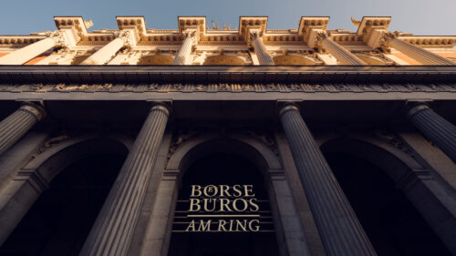 The Alte Börse building features a grand entrance framed by towering columns and intricate architectural details, symbolizing its historical importance and stately presence along the Ringstrasse.