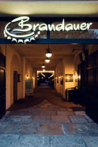 Cozy interior of Brandauer's Schlossbräu in Vienna, offering a warm dining experience.