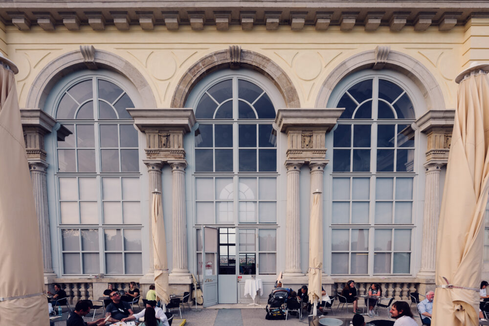 Charming outdoor terrace at Café Gloriette, perfect for enjoying a meal in Vienna's lush surroundings.