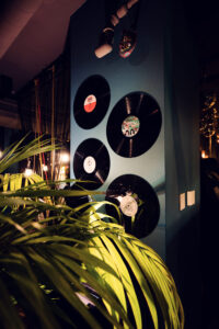 Vinyl records at Der Dachboden, evoking the vibrant energy of a DJ set in Vienna's rooftop bar.