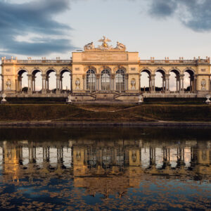 Gloriette at Schönbrunn reflected in the pond at golden hour.