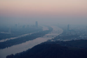 Majestic Danube River curves viewed from Leopoldsberg summit, where the historic river creates dramatic bends through Vienna's landscape.