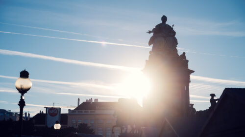 Majestic sunset at Maria-Theresien-Platz, where golden light bathes the Maria Theresa Monument in warm hues.