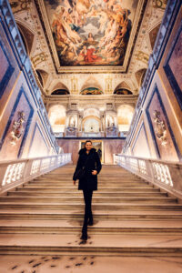 Adriana posing on main staircase at Natural History Museum Vienna (Naturhistorisches Museum Wien), photographed on marble steps.