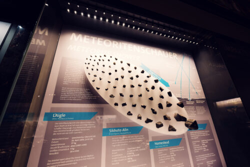 Stony meteorite display at Natural History Museum Vienna (Naturhistorisches Museum Wien), showing chondrite specimens from outer space in geological collection on Maria-Theresien-Platz.