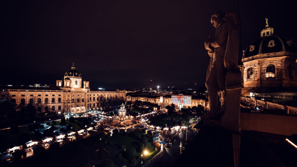 Natural History Museum Vienna during Christmas market (Naturhistorisches Museum Wien), featuring Renaissance Revival architecture with festive wooden stalls on Maria-Theresien-Platz.