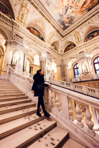 Portrait of Adriana at Natural History Museum Vienna (Naturhistorisches Museum Wien), photographed in ornate museum interior.