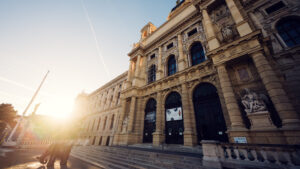 Natural History Museum Vienna at sunset (Naturhistorisches Museum Wien), featuring Renaissance Revival architecture with golden hour lighting and warm glow on classical facade at Maria-Theresien-Platz.