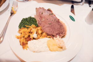 Plachutta's expertly carved Tafelspitz, showcasing tender slices of prime beef arranged with root vegetables and bone marrow.