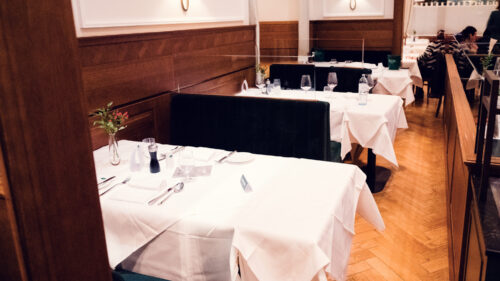 Classic table arrangement at Plachutta featuring crisp white linens and premium tableware.