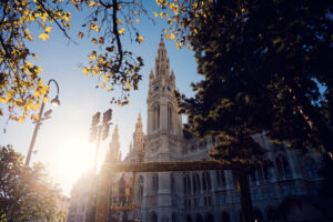 Rathaus Vienna at sunset with golden light illuminating its limestone facade.