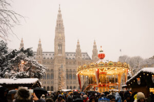 Rathaus Vienna during Christmas market season with festive decorations and lighting.