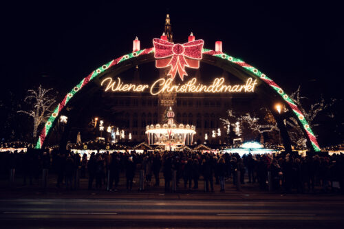 Vienna Christmas World at Rathausplatz with traditional wooden stalls and the neo-Gothic City Hall backdrop.