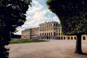 Schönbrunn Palace Schloss Schönbrunn baroque facade with colorful flower gardens in foreground.