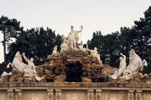 Neptune Fountain at Schönbrunn Palace gardens with baroque sculpture and water features.