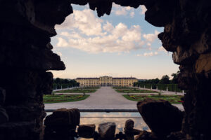 Neptun baroque fountain with mythological figures and palace view behind.