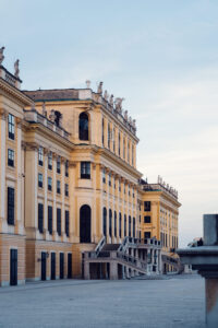 Schönbrunn Palace back entrance with imperial yellow walls and ornate baroque architectural details.